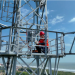 A technician of China Unicom installs devices on a 5G base station to further marine internet construction. Photo and caption by sasac.gov.cn.